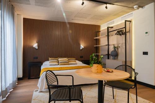 a bedroom with a bed and a table and chairs at BUBU Apartments By Charming Stay in Málaga