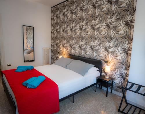 a bedroom with a bed with a red and white blanket at Bragadin75 In Vaticano in Rome