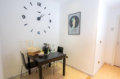 a room with a table and a clock on the wall at Bragadin75 In Vaticano in Rome