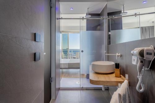 a bathroom with a sink and a shower at Hibrido Boutique Hotel & Spa in Sciacca