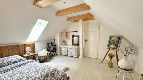 a bedroom with a bed and a painting on the wall at Dom na hradbách in Levoča