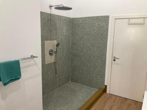 a bathroom with a shower with a glass door at Cantinho do Carmo in Fragoso