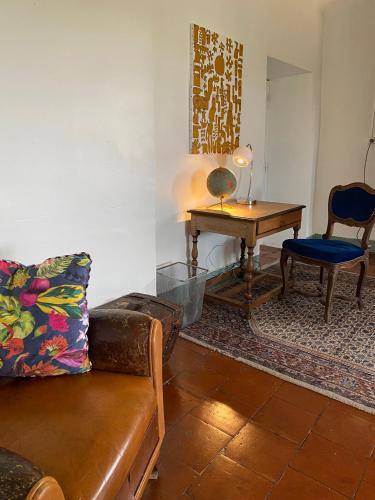 a living room with a couch and a table at Chateau de Montcuquet in Lautrec