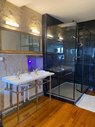 a bathroom with two sinks and a shower at Chateau de Montcuquet in Lautrec