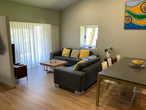 a living room with a couch and a table at Cantinho do Carmo in Fragoso