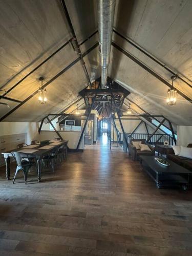 a large room with tables and chairs in a building at Upscale Industrial Penthouse in Plymouth