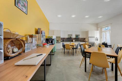 a kitchen and dining room with tables and chairs at B&B Bellagio Davos in Davos