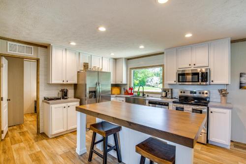 a kitchen with white cabinets and a wooden counter top at Cedar Creek Reservoir Home with Private Boat Ramp! in Seven Points