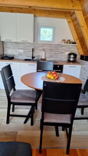 a kitchen with a table with a bowl of fruit on it at Bella Home in Rap