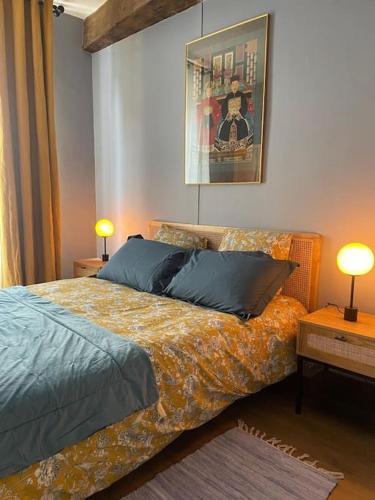 - une chambre avec un lit, deux lampes et deux tables dans l'établissement Coeur de ville Mortagne-au-Perche, à Mortagne-au-Perche