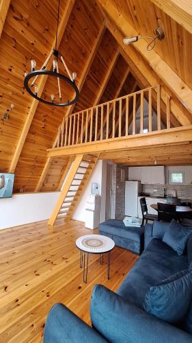 a living room with a blue couch and a staircase at Bella Home in Rap