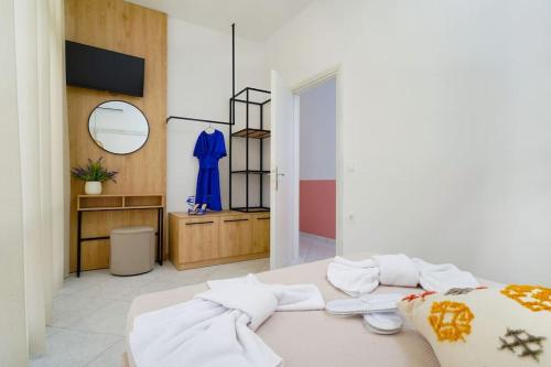 Habitación con cama, espejo y vestidor. en Aesthesis Luxury Retreat, en Skala Sotiros