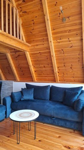 a blue couch in a living room with a table at Bella Home in Rap