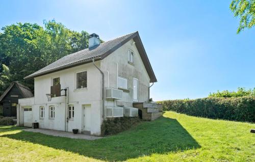 an old white house on a grassy field at Gorgeous Home In Fredericia With Wifi in Fredericia