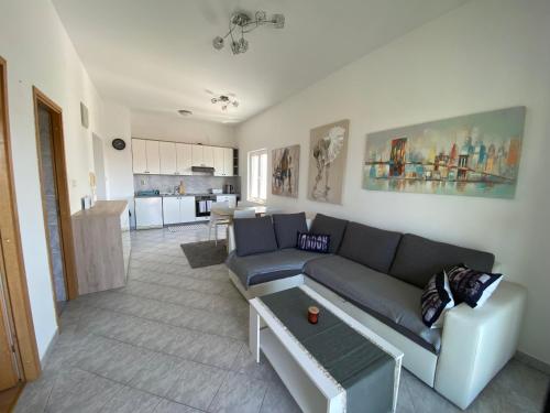 a living room with a couch and a table at Apartman Sunset in Biograd na Moru