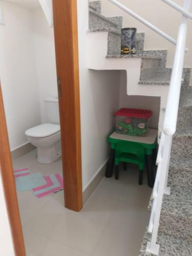 a doll house bathroom with a toilet and stairs at sobrado 08 com duas suítes, conf in Guarujá