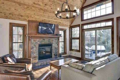 a living room with a couch and a fireplace at Les Falaises Mont Tremblant Luxury Ski Retreat in Mont-Tremblant