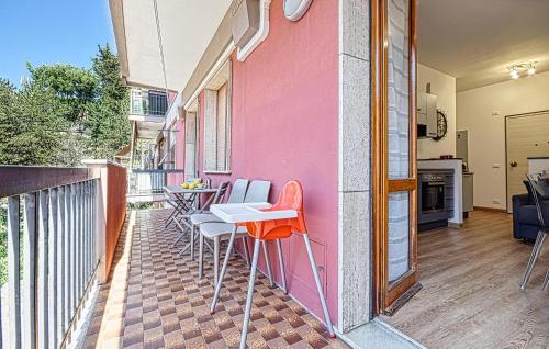 a balcony with a table and chairs on a pink wall at 1 Bedroom Lovely Apartment In Recco in Recco