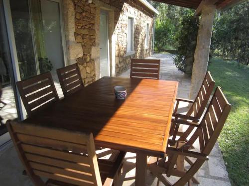 a wooden table and chairs on a patio at Cantinho do Carmo in Fragoso