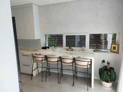 a kitchen with a island with bar stools at Big Mama Koala in Druskininkai