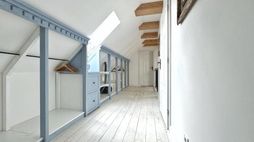 a hallway of a house with blue and white walls at Dom na hradbách in Levoča