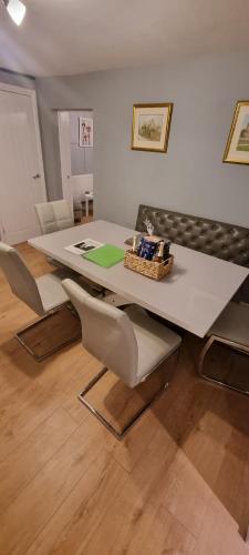 a table and chairs in a living room with a table at 'rose cottage' a 19th century cottage in Findern in Findern