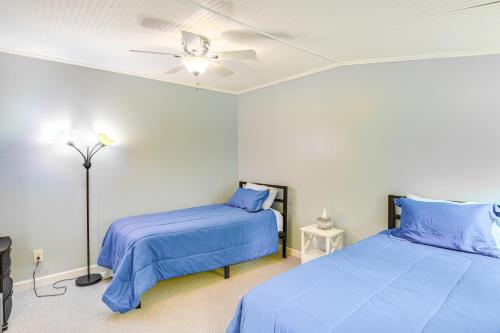 a bedroom with two beds and a ceiling fan at Bayfront Steuben Home with Screened Porch and Fire Pit in Steuben