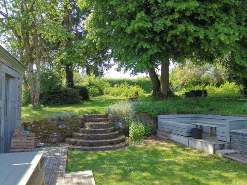 a garden with stairs and a tree and grass at Le repos Ardenne (Fays-Famenne) in Wellin