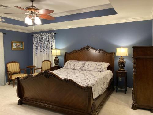 a bedroom with a large bed and a blue wall at Entire lake house at Lake Fork with private bay, boat ramp, fishing light & 8 acres land in Alba