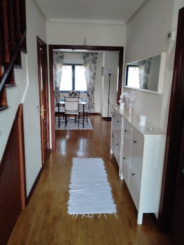a living room with a table and a white rug at La Casina Azul de May in San Juan de la Arena