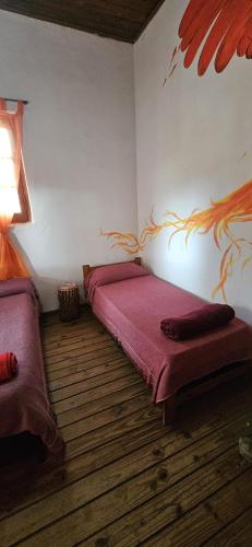 Ένα ή περισσότερα κρεβάτια σε δωμάτιο στο Hunab Ku Hostel
