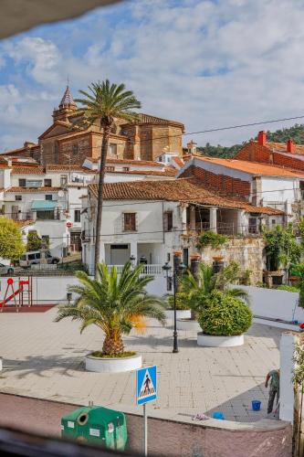 a city with buildings and palm trees and a street at Casa Rural en Galaroza in Galaroza