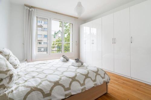 une chambre avec un lit avec deux animaux en peluche dessus dans l'établissement Splendide 2 pièce à Boulogne, à Boulogne-Billancourt