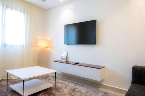 a living room with a tv on a wall at TheCasaEdition - Gueliz Residency in Marrakech