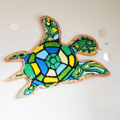 a stained glass turtle cookie on a white surface at Paradise Beach Oasis in Indialantic