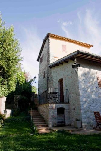 an old stone building with stairs and a balcony at Casale del Monsignore in Spoleto