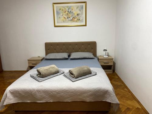 a bedroom with a bed with two pillows on it at Apartment Luka in Ljubuški