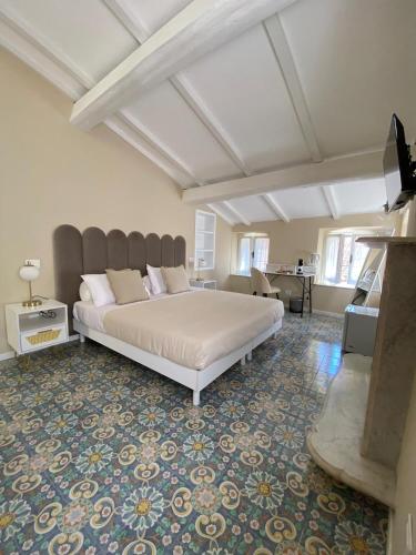 a bedroom with a large bed and a living room at Fiasella 21 in Sarzana