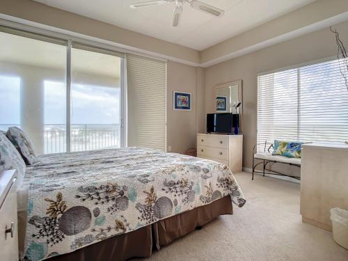 a bedroom with a bed and a large window at Penthouse Condo with wrap around views of the ocean - SR802 in Edgewater