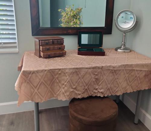 a table with a laptop on it with a mirror at Paradise Beach Oasis in Indialantic