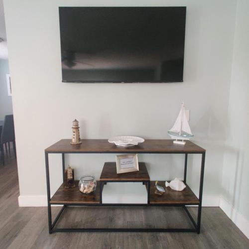 a wooden console table with a model boat on it at Paradise Beach Oasis in Indialantic