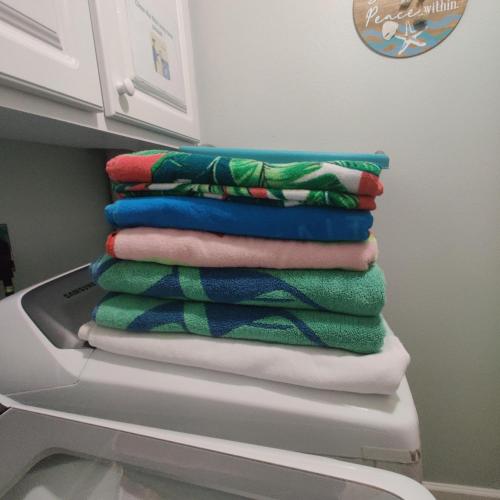 a stack of towels sitting on top of a refrigerator at Paradise Beach Oasis in Indialantic