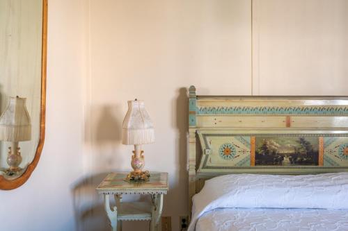 a bedroom with a bed and a table with a lamp at Martine Inn in Pacific Grove