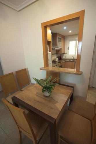 a dining room with a table and a mirror at Apartalux Magic Diamond in Oropesa del Mar