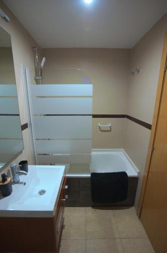 a bathroom with a bath tub and a sink at Apartalux Magic Diamond in Oropesa del Mar