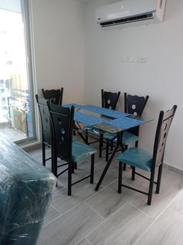 a dining room table with chairs and a blue table at Espectacular Apartamento Ricaurte Girardot in Ricaurte