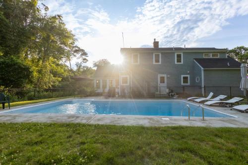 a house with a swimming pool in front of a house at Private Pool and Screened Deck Mashpee Home! in Mashpee