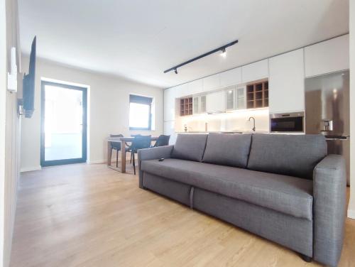 a living room with a couch and a kitchen at Casa Náutica T2 in Ovar