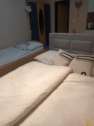 a row of beds in a room at Studio apartman Salopek in Ogulin