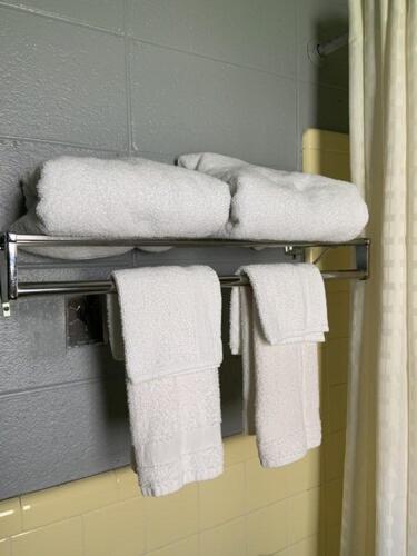 a bathroom with white towels on a towel rack at Paradise Suites - Newport News & Jefferson Ave in Newport News